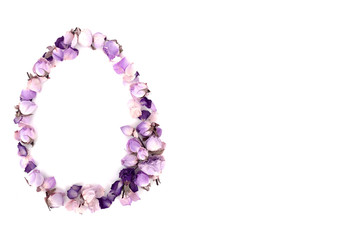The outline is in the form of an Easter egg, made of purple and pink small roses on a white background.