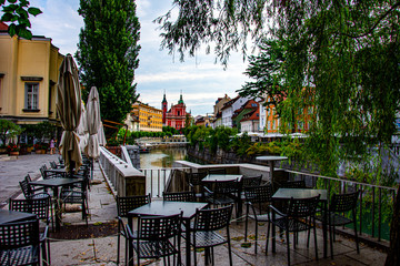 Fototapeta na wymiar Empty restourant in the city of Ljubljana center, viewing to the river Ljubljanica and the church