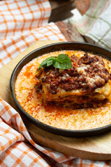 Traditional italian dish. Lasagna made with minced beef bolognese sauce and bechamel sauce topped with basil leaves