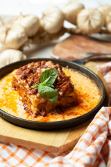 Traditional italian dish. Lasagna made with minced beef bolognese sauce and bechamel sauce topped with basil leaves