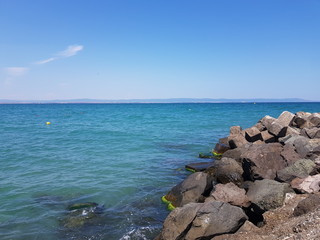 Pier of the town of Pomorie / Bulgaria, covered with breakwaters around, which protects the beach and the city from strong waves. Beautiful view during summer time vacation of Black Sea.