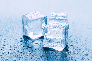 Pyramid of beautiful thawed ice cubes with drops of water