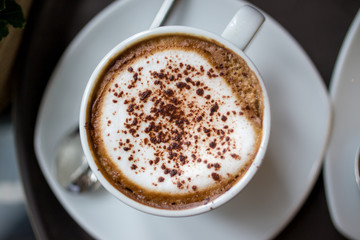 top view cappuccino coffee on table cloths backgeound