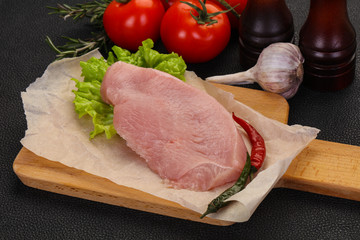 Raw Turkey steak served rosemary