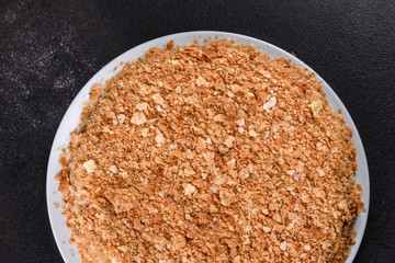 Fresh delicious cake napoleon with cream on a dark background