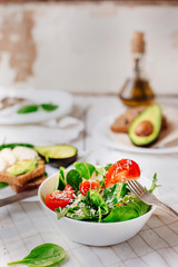 Akavado with cherry tomatoes, mozzarella, basil with olive oil. Healthy food. Selective focus. Vegetarian food