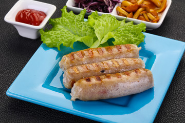 Grilled sausages served mushrooms and cabbage
