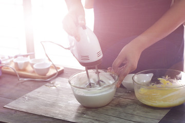 cooking from home , she is cooking cake at home