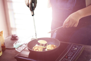 cooking from home , she is cooking cake at home