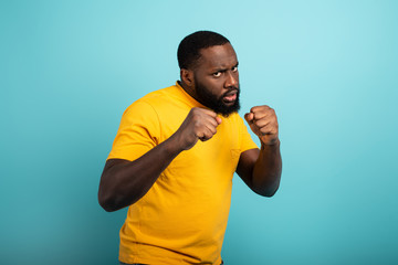 Man attacks with a punch the covid19 coronavirus. Blue background