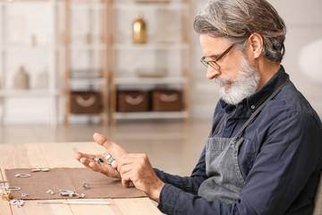 Jeweler examining gemstones in workshop