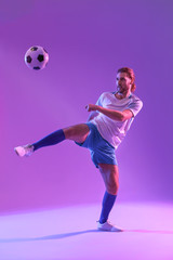 Obraz premium Male football player on color background