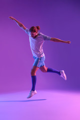 Fototapeta na wymiar Male football player on color background