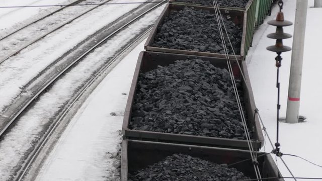 freight train transports coal. Full wagons loaded with minerals