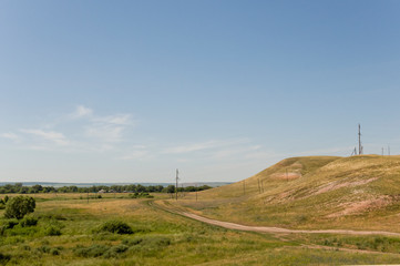 Soft landsсape with yellow meadows and forests far away. Light blue sky. Fall fields 