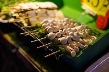 bbq stick, small baby mushroom in the sticks at local street food in night market, thailand