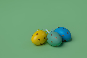 Easter eggs on a green background. Blue yellow green eggs