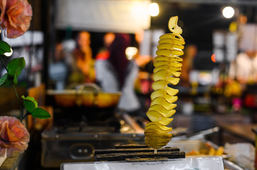 Fried potato springs. Street food on a stick at Thailand night market