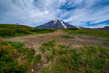 Panoramic view of the city Petropavlovsk-Kamchatsky and volcanoes: Koryaksky Volcano, Avacha Volcano, Kozelsky Volcano. Russian Far East, Kamchatka Peninsula.