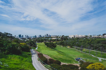 Fototapeta na wymiar view of golf course with city skyline 