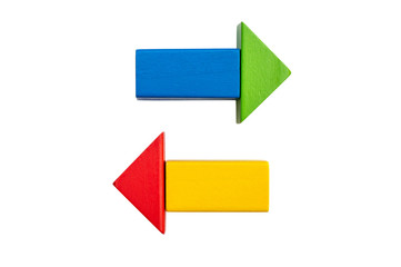 Arrows from wooden toy bricks on white.