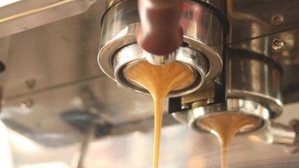 Advertising, business, beverage , lifestyle concept making fresh coffee going out from a coffee espresso machine. barista making coffee preparation service in coffee shop.