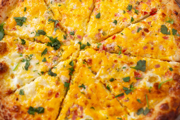 A closeup view of a breakfast pizza pie, as a background.