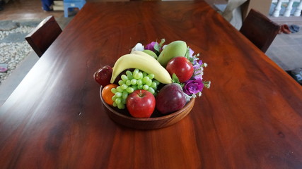 Tray, plastic fruit on the table.