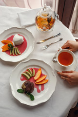 Beautiful smiling women drinking tea at cozy cafe.
