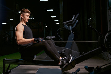 Fototapeta na wymiar Bodybuilder training back on exercise machine.