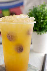 A closeup view of a kumquat fruit tea drink.