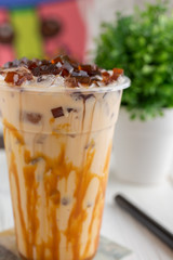 A closeup view of an Asian milk tea beverage in a restaurant or kitchen setting.