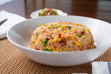 A view of a bowl of fried rice, in a restaurant or kitchen setting.