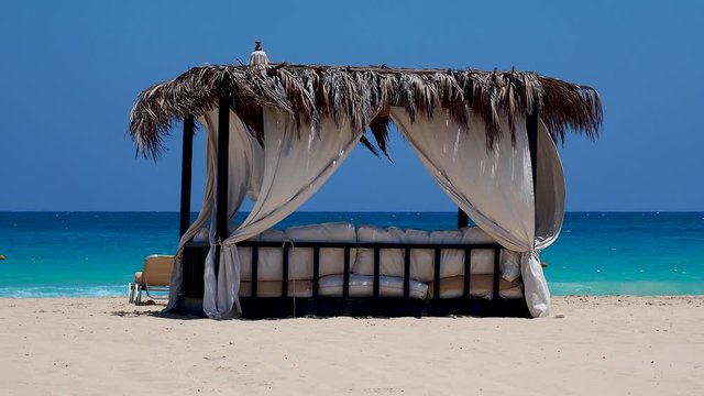 Marsa Matruh, Egypt. Elegant gazebo on the beach. Amazing sea with tropical blue, turquoise and green colors. Relaxing context. Nobody on the beach. Fabulous holidays. Mediterranean Sea. North Africa