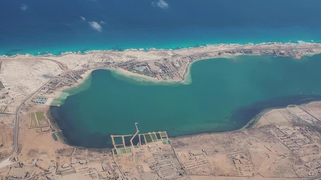 Earth's line. A perspective of the ground's colors and shapes. Aerial view of the Egyptian coast close to the town of Marsa Matruh. Overlooking the Mediterranean sea. View from the airplane window