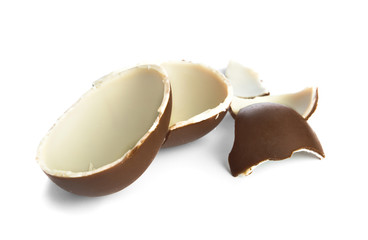 Broken chocolate egg on white background