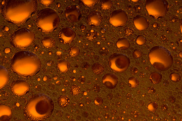 red orange color background from mixed water and oil bubbles. close up