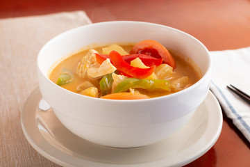 A view of a bowl of pineapple curry on display in a restaurant or kitchen setting.