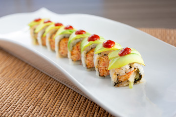 A view of a Mexican roll sushi plate, in a restaurant or kitchen setting.