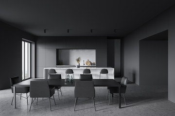 Gray and white kitchen with bar and table