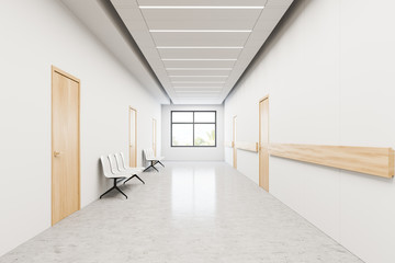 Chairs in hospital corridor with doors