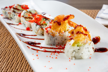 A view of a shrimp tempura roll, in a restaurant or kitchen setting.