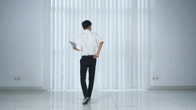 Young businessman dancing to express his success