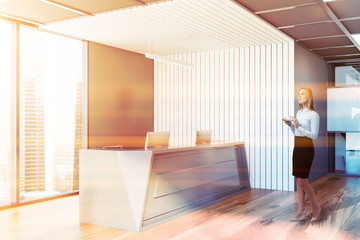 Woman in white and gray office with reception