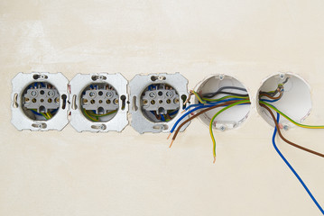 Electrician install outlets on beige wall with eu standards