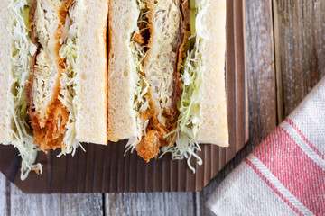 A closeup view of a Japanese soft-shelled crab Sando in a restaurant or kitchen setting.