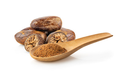 Nutmeg powder in wood spoon on white background
