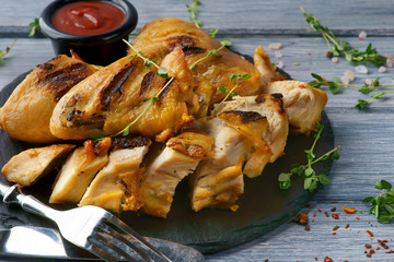 grilled chicken with barbecue sauce on a wooden background
