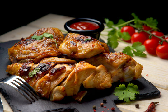 grilled chicken with barbecue sauce on a wooden background