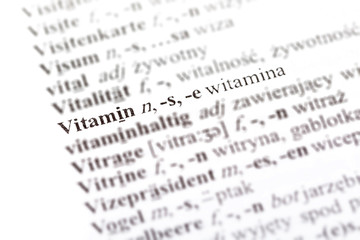 Word vitamin - witamina in a Polish - German dictionary line pointed out, selective focus, macro, closeup, detail Medicine supplementation, immunity foreign language medical translation simple concept